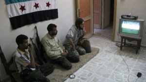 Syrian rebels watching a football match