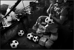 Football against War - Seaman Chris Welch, 27, pumps up soccer balls which will later be given while the Navy's Riverines are out on patrol in Iraq.  Photography: Ross Taylor