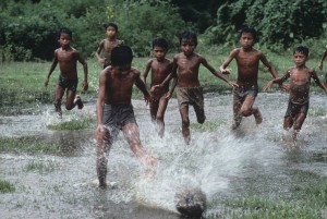 Happiness is barefoot football on the grass in the rain...  Pic courtesy: Steve McCurry