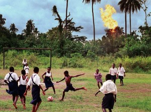 Schoolchildren in the Nigerian village of Akaraolu play football while the nearby Oshie gas flare roars. Photograph: Chris Hondros