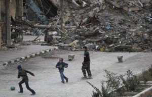  Children play football in a damaged street in Deir al-Zor, eastern Syria.